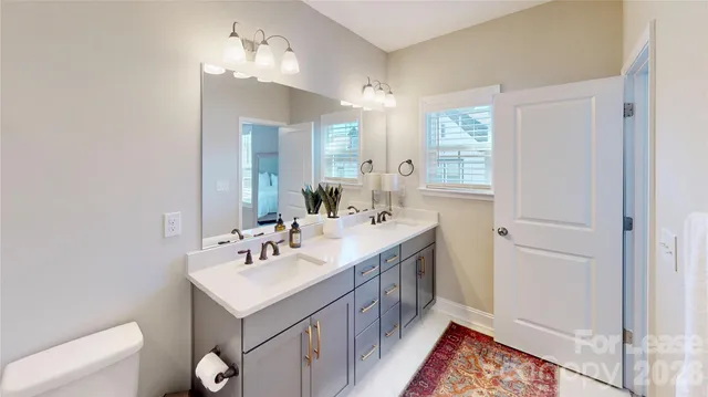 a bathroom with a sink a mirror and a shower