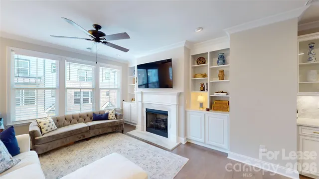 a living room with furniture flat screen tv and a fireplace