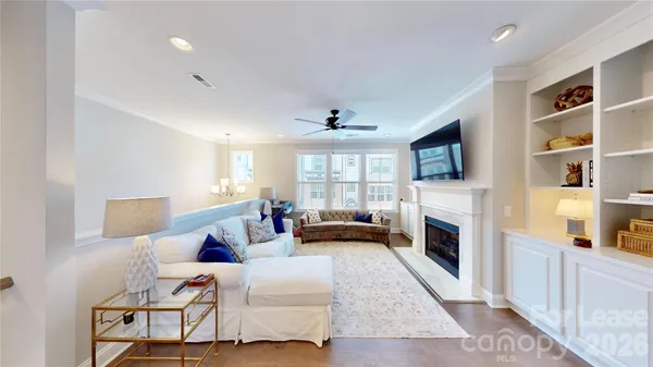 a living room with furniture fireplace and flat screen tv