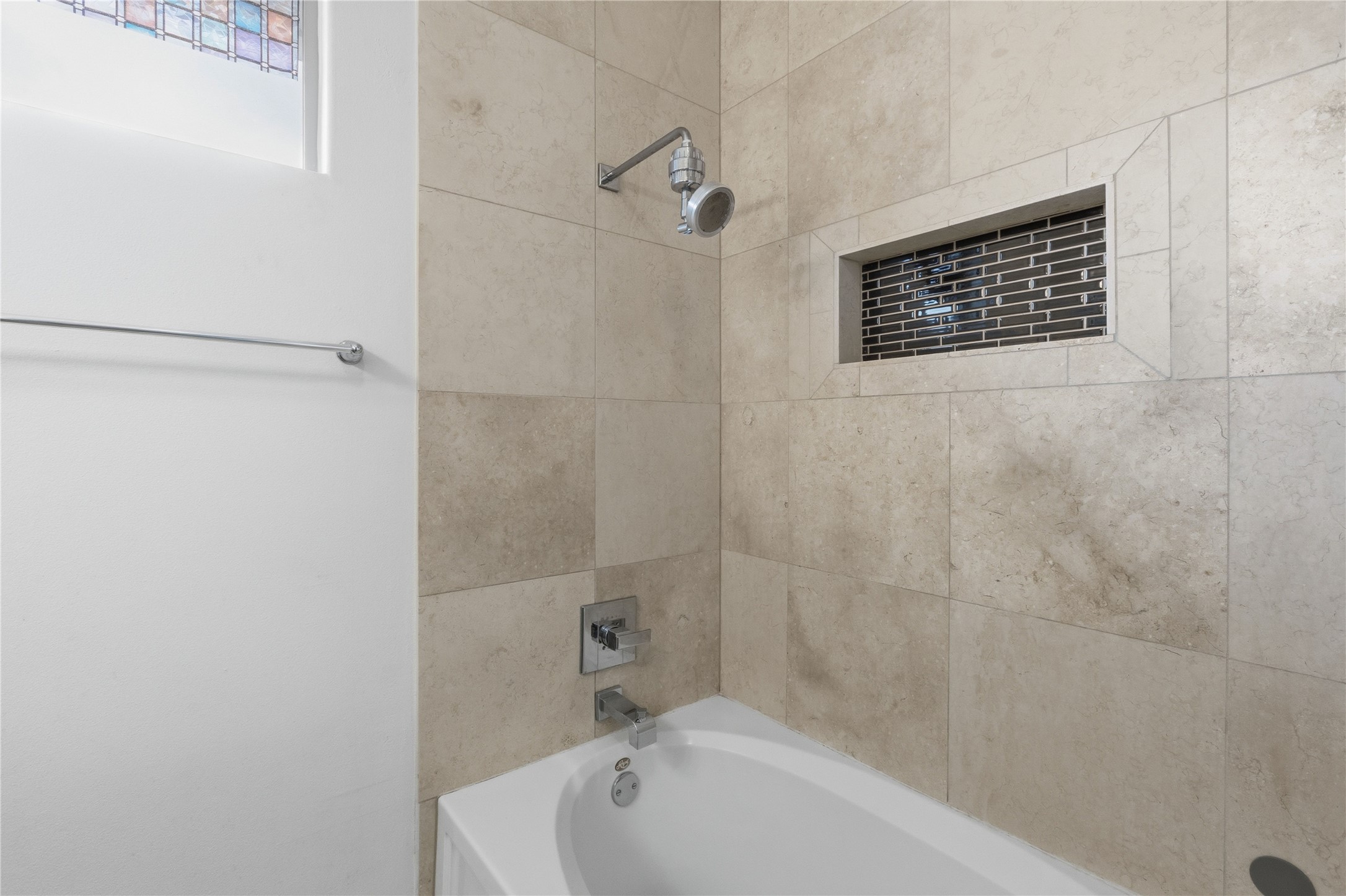 4124 Valley View Road, Unit 4A & 4B Austin, TX 78704 - Photo 37 of 40 A well-appointed bath with tiled walls and an integrated shower niche, ready for unwinding.
