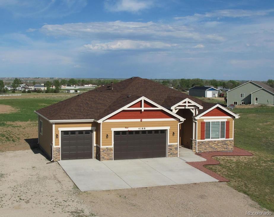 an aerial view of a house with a yard and balcony