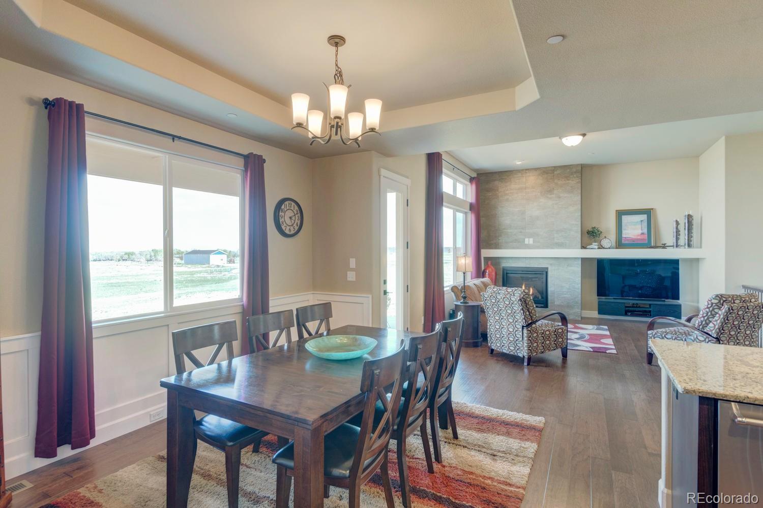 4188 Meadowlark Road Fort Lupton, CO 80621 - Photo 11 of 36 a view of a dining room with furniture window and wooden floor