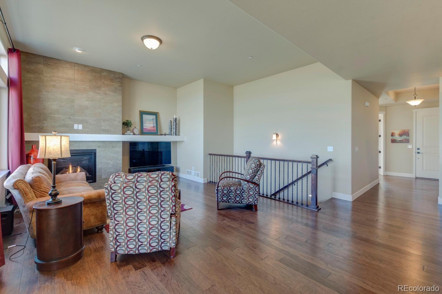 4188 Meadowlark Road Fort Lupton, CO 80621 - Photo 14 of 36 a living room with furniture and a wooden floor