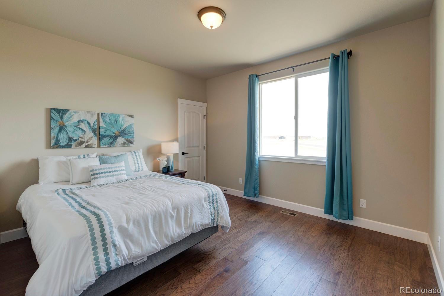 4188 Meadowlark Road Fort Lupton, CO 80621 - Photo 16 of 36 a bedroom with a bed and a window