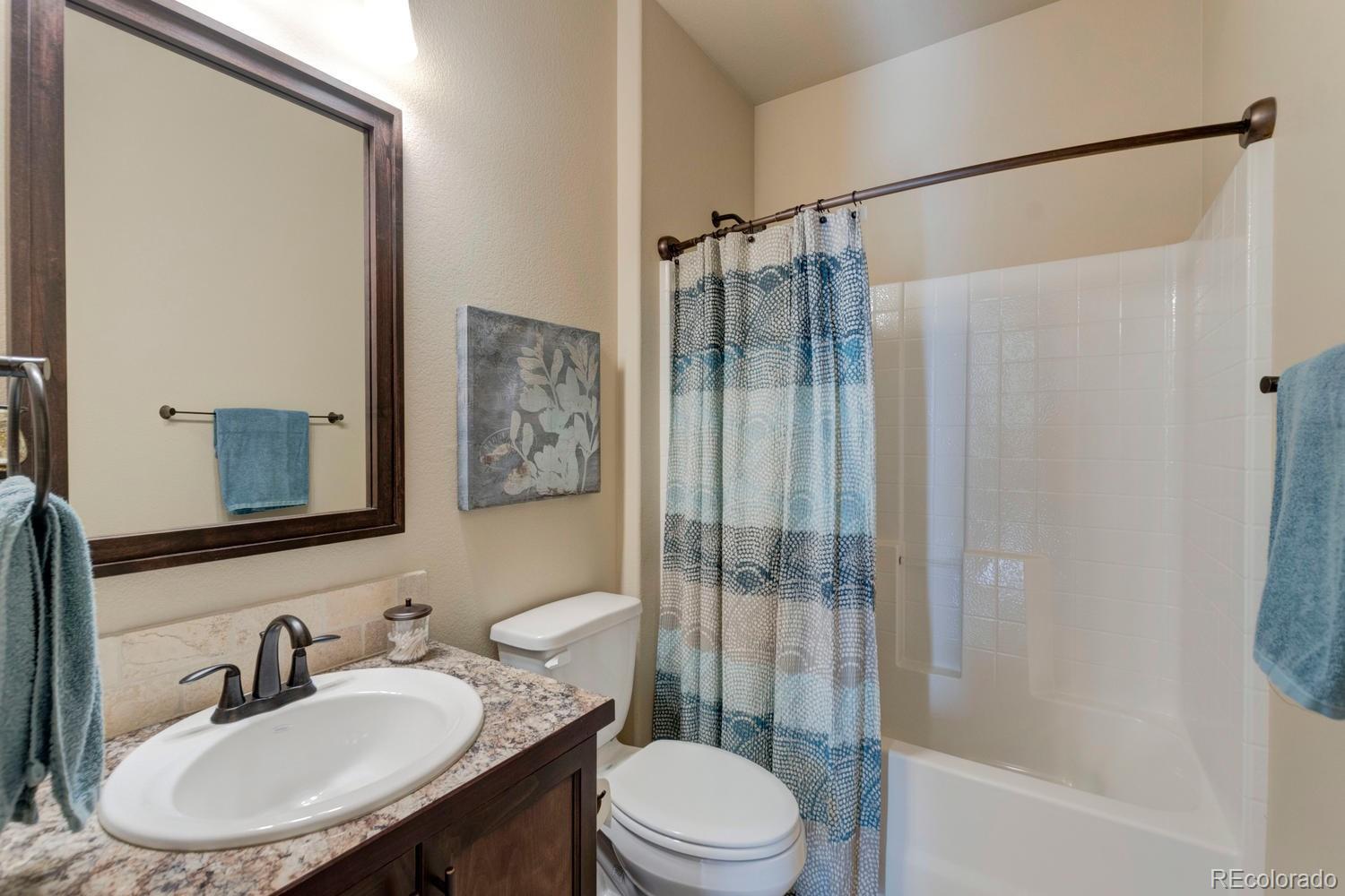 4188 Meadowlark Road Fort Lupton, CO 80621 - Photo 17 of 36 a bathroom with a sink toilet and shower