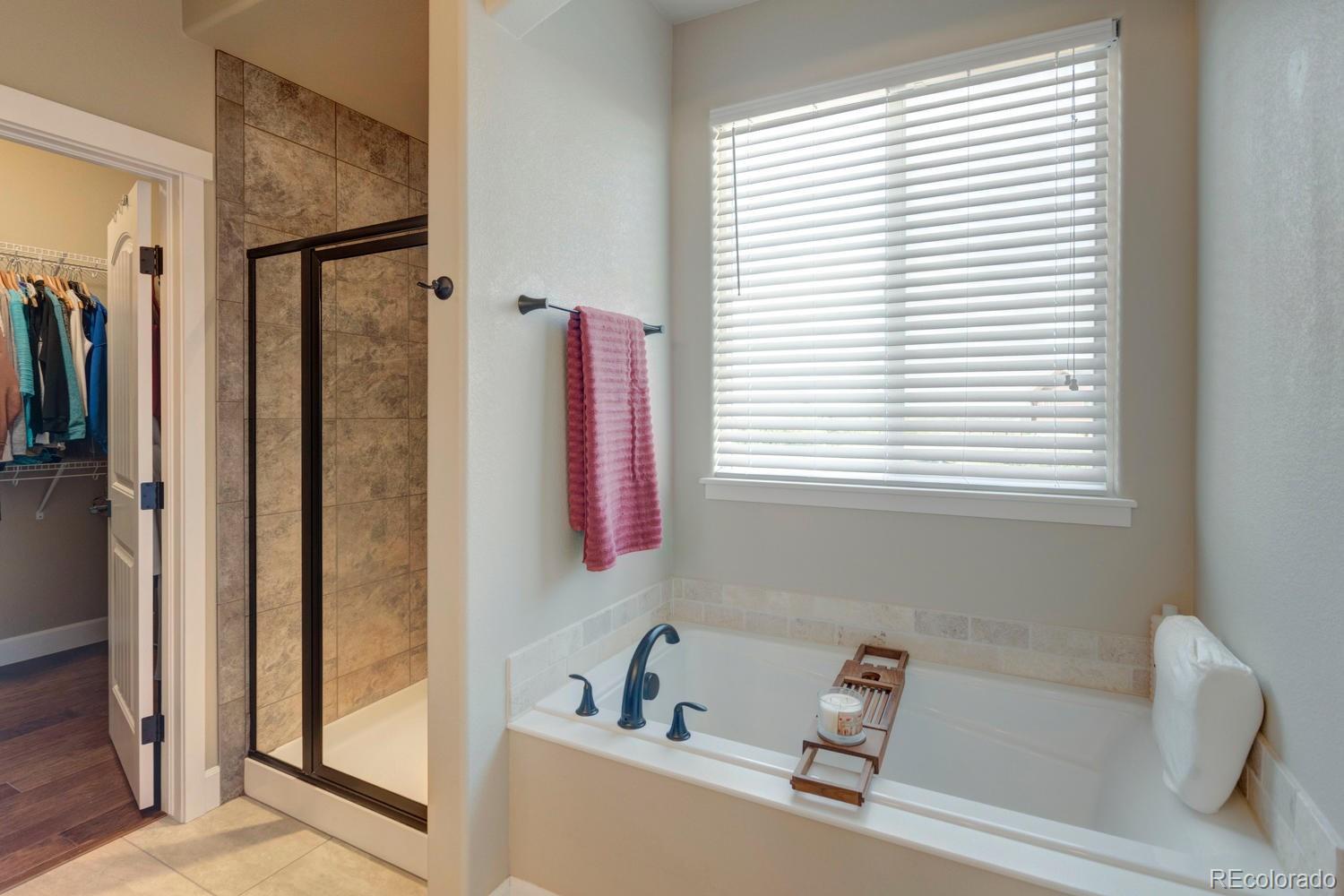 4188 Meadowlark Road Fort Lupton, CO 80621 - Photo 22 of 36 a bathroom with a bathtub and a window