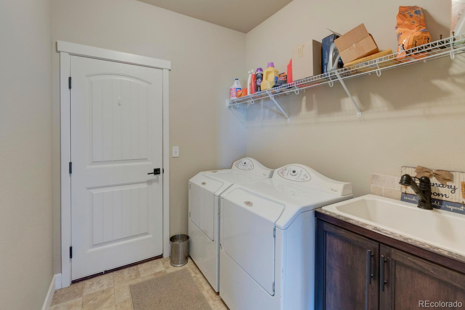 4188 Meadowlark Road Fort Lupton, CO 80621 - Photo 23 of 36 a utility room with dryer and washer