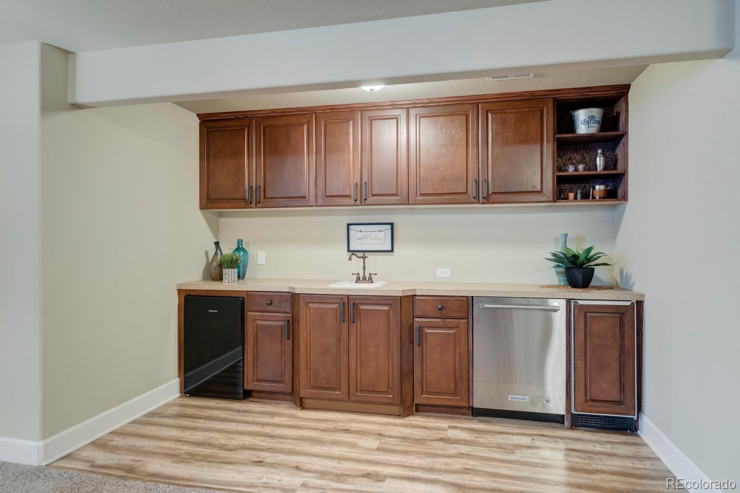 4188 Meadowlark Road Fort Lupton, CO 80621 - Photo 25 of 36 a kitchen with stainless steel appliances granite countertop a sink and cabinets