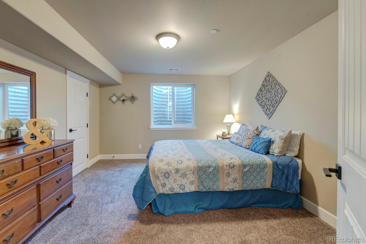 4188 Meadowlark Road Fort Lupton, CO 80621 - Photo 27 of 36 a bedroom with a bed and a window