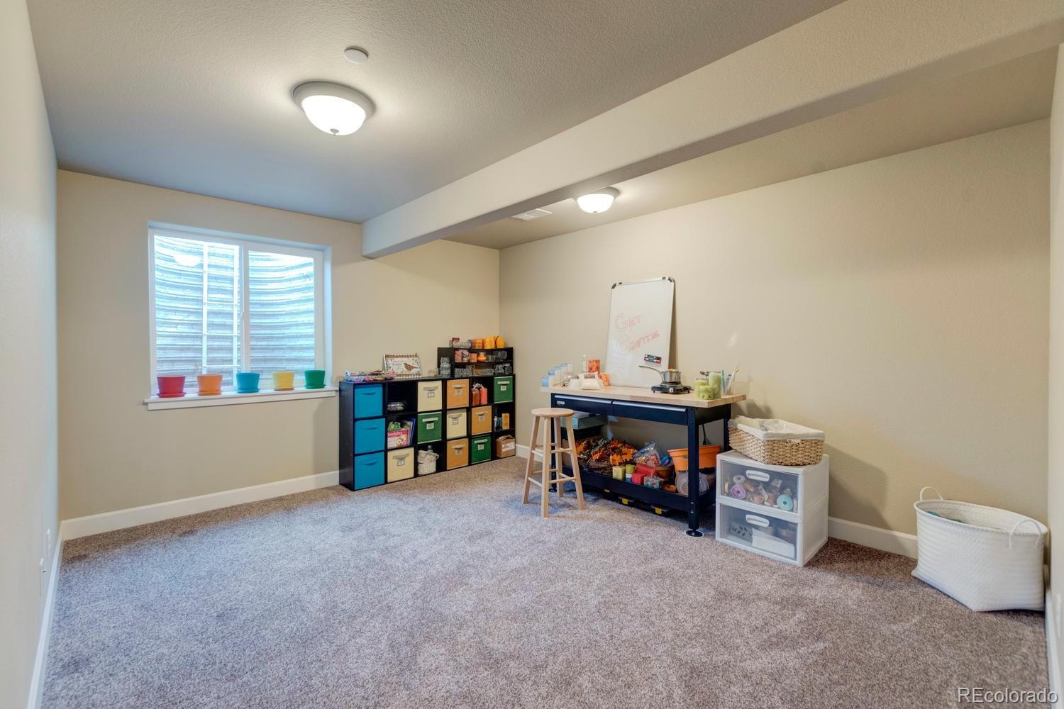 4188 Meadowlark Road Fort Lupton, CO 80621 - Photo 29 of 36 a view of a room with furniture and a window