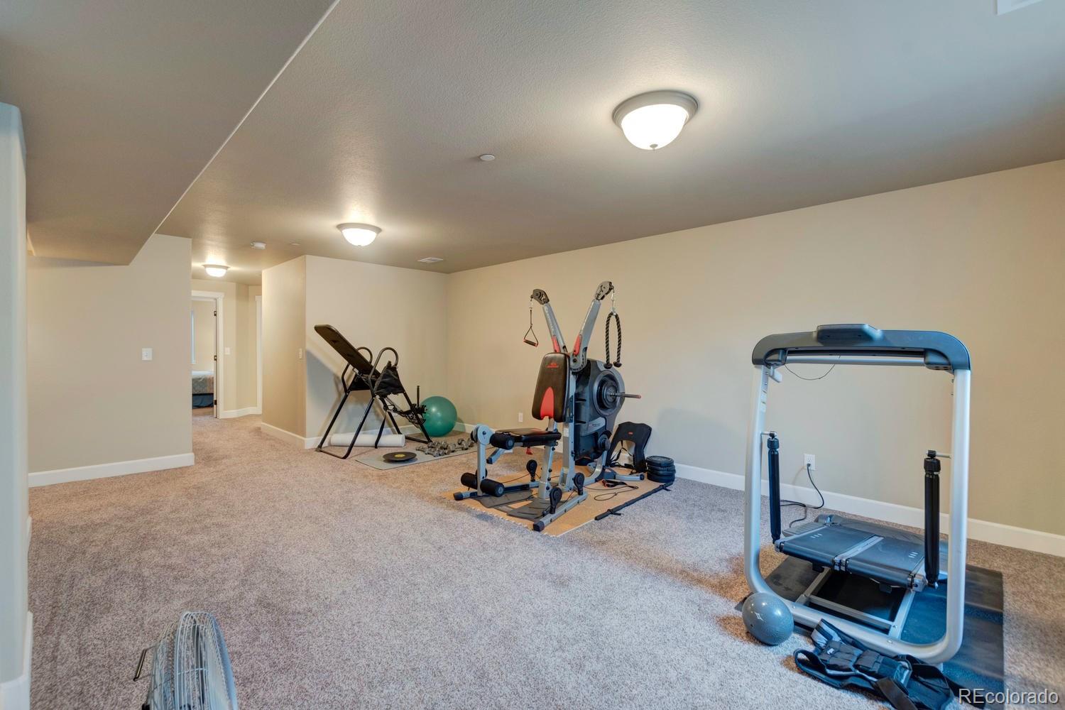 4188 Meadowlark Road Fort Lupton, CO 80621 - Photo 30 of 36 a view of a room with gym equipment