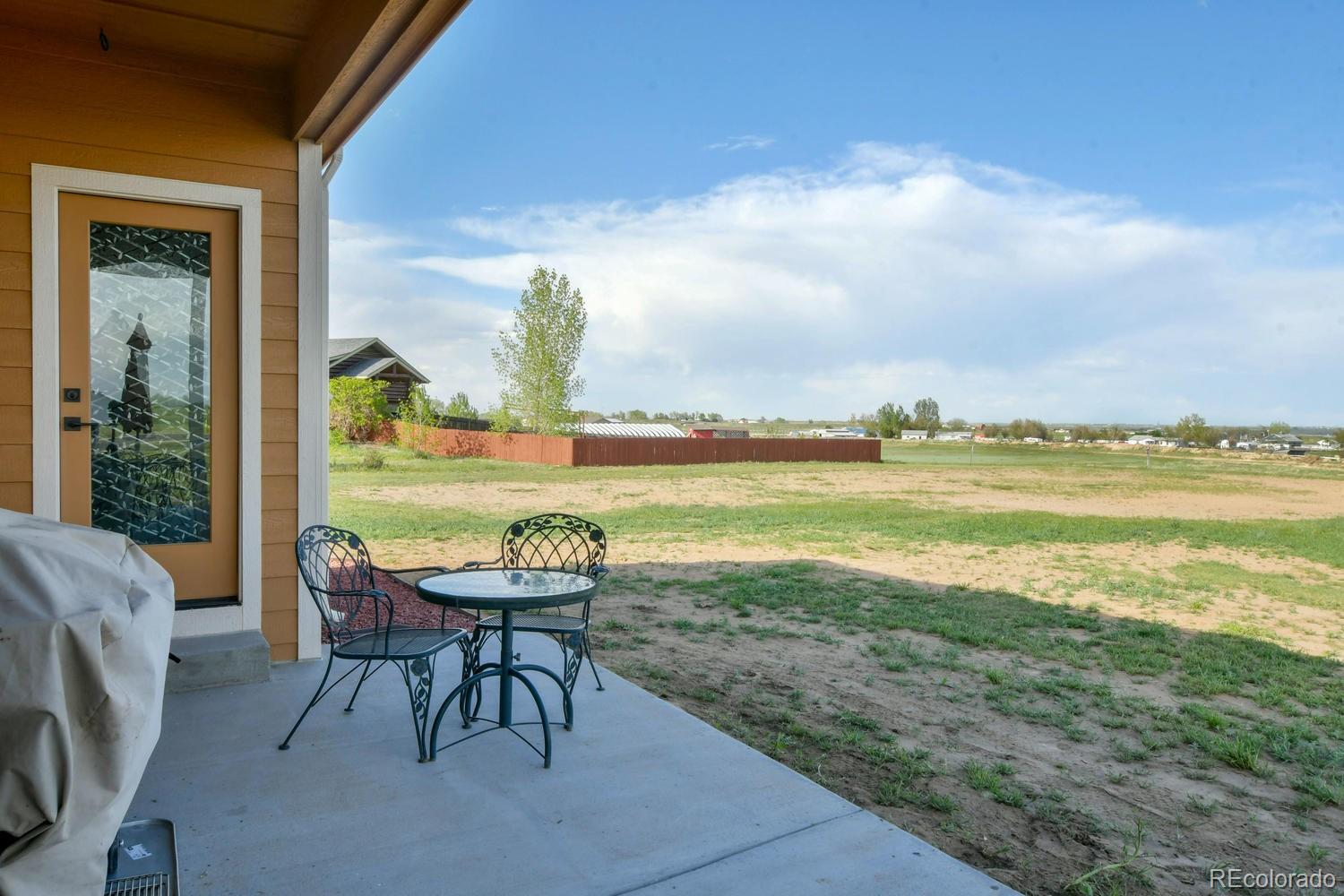 4188 Meadowlark Road Fort Lupton, CO 80621 - Photo 34 of 36 a view of a lake with furniture