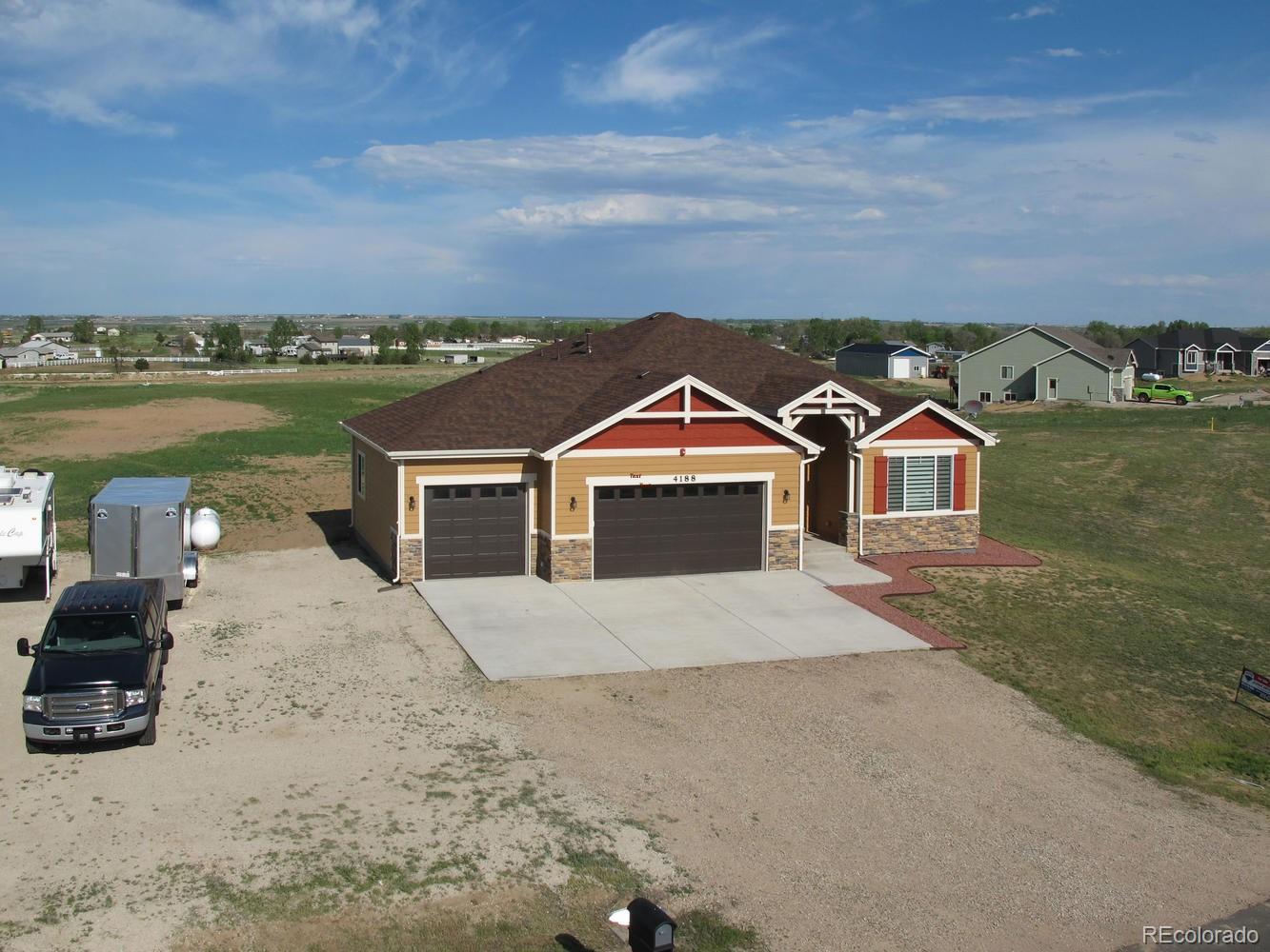 4188 Meadowlark Road Fort Lupton, CO 80621 - Photo 36 of 36 a front view of a house with a yard