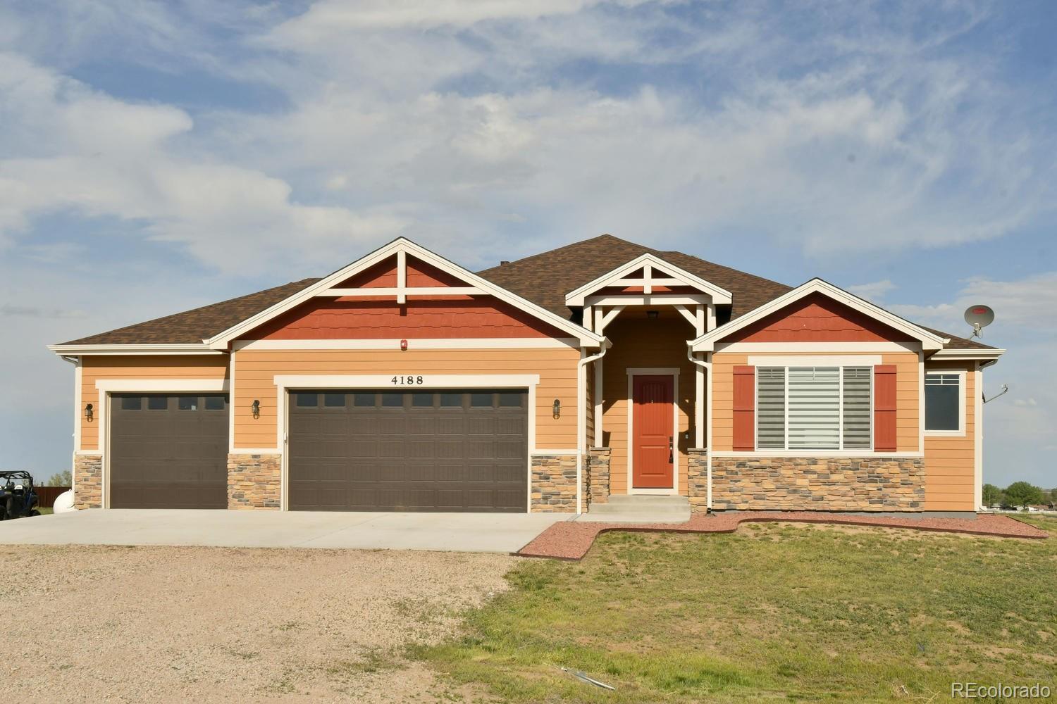 4188 Meadowlark Road Fort Lupton, CO 80621 - Photo 4 of 36 a front view of a house with a yard and garage