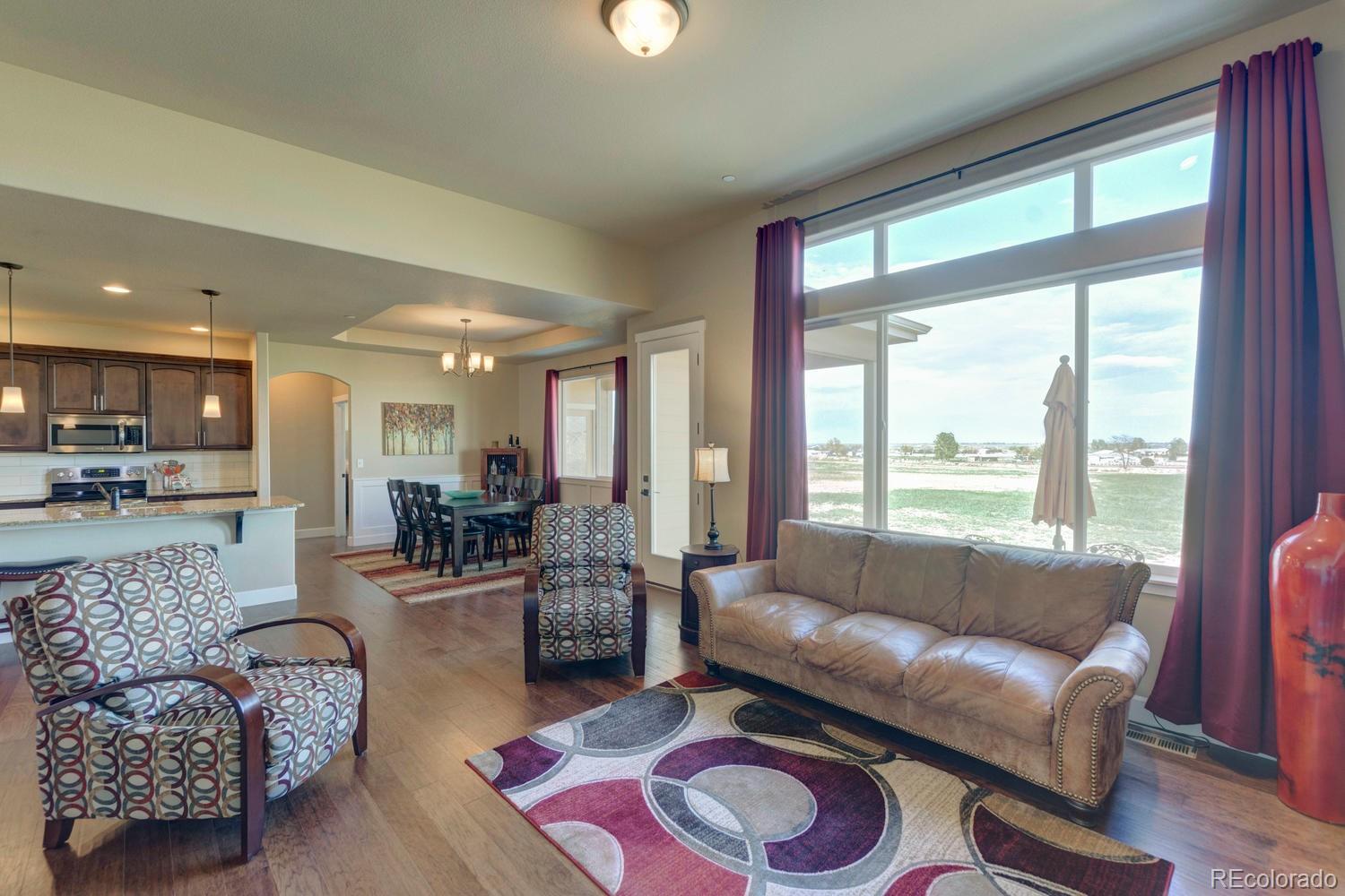 4188 Meadowlark Road Fort Lupton, CO 80621 - Photo 5 of 36 a living room with furniture and a large window