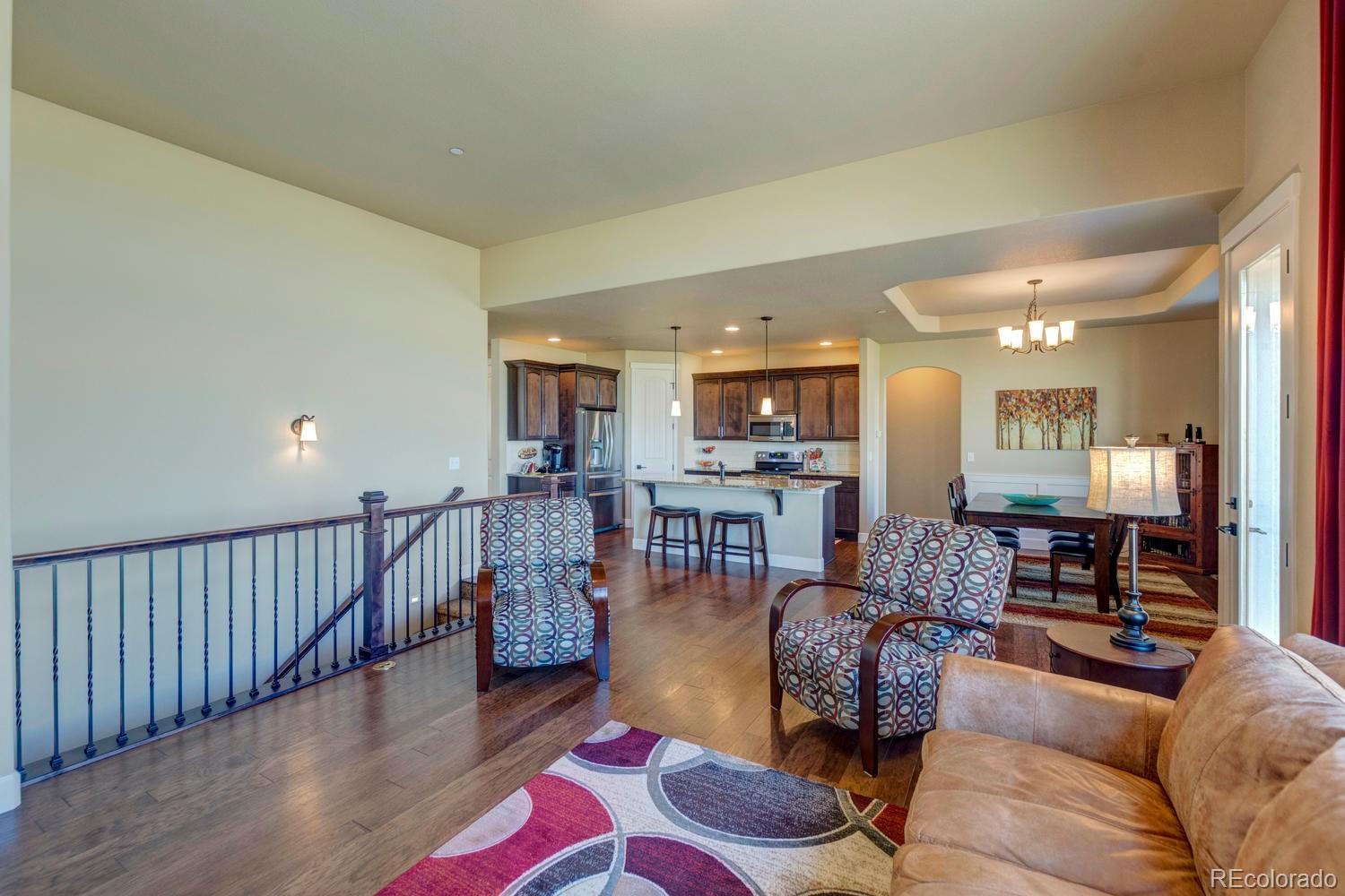 4188 Meadowlark Road Fort Lupton, CO 80621 - Photo 6 of 36 a living room with furniture and wooden floor