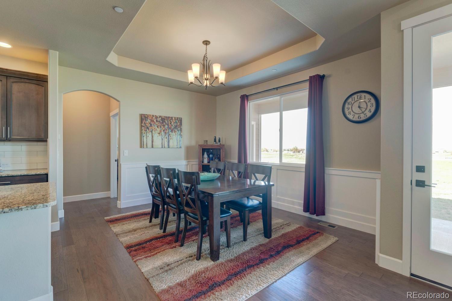 4188 Meadowlark Road Fort Lupton, CO 80621 - Photo 10 of 36 a view of a dining room with furniture window and wooden floor