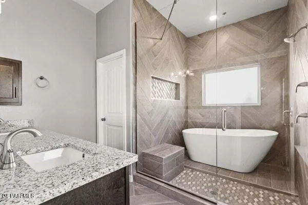 a spacious bathroom with a sink and a mirror