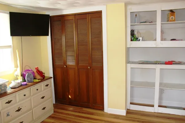 a view of an entryway with wooden cabinet