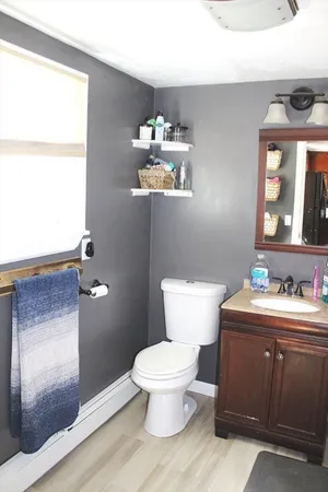 a bathroom with a toilet a sink and a mirror