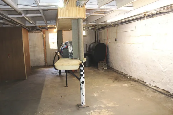 a view of a room with a table and chairs