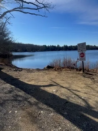 a view of a lake next to a yard