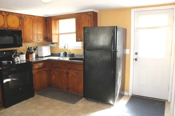 a kitchen with a refrigerator and a stove