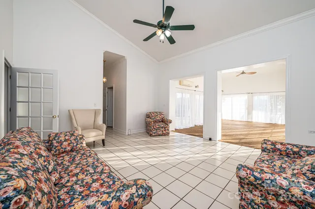 a bedroom with double bed and a chandelier