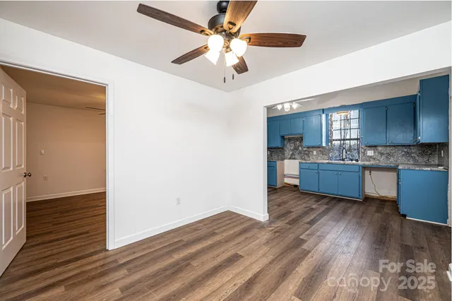 a view of kitchen with granite countertop cabinets and wooden floor