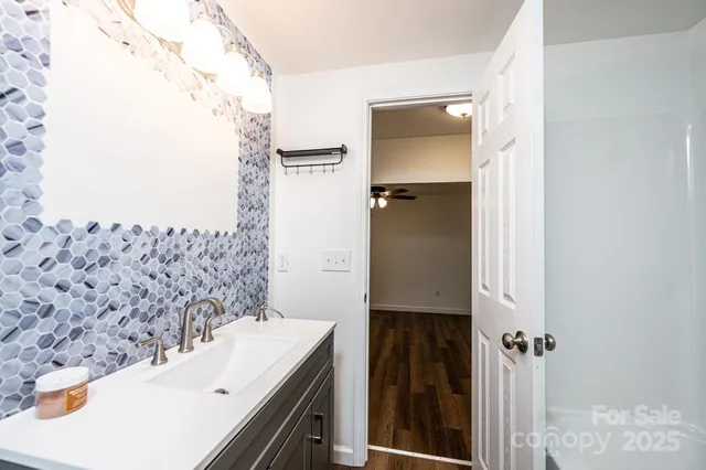 view of a bathroom with a sink and mirror