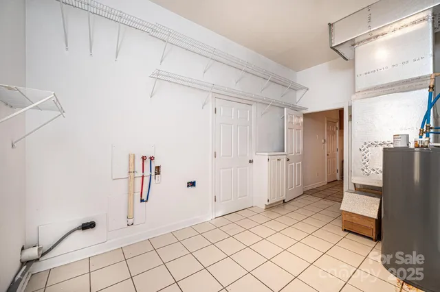 a view of a kitchen with white cabinets and refrigerator