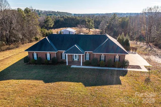 a view of house with yard and lake view