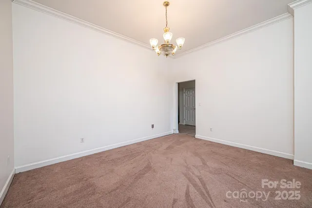 a view of an empty room with a chandelier