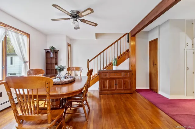 a view of a dining room with furniture window and wooden floor