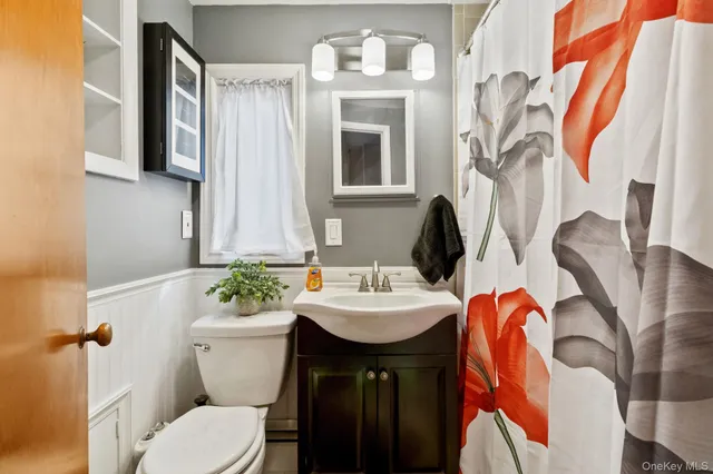 a bathroom with a sink toilet and mirror