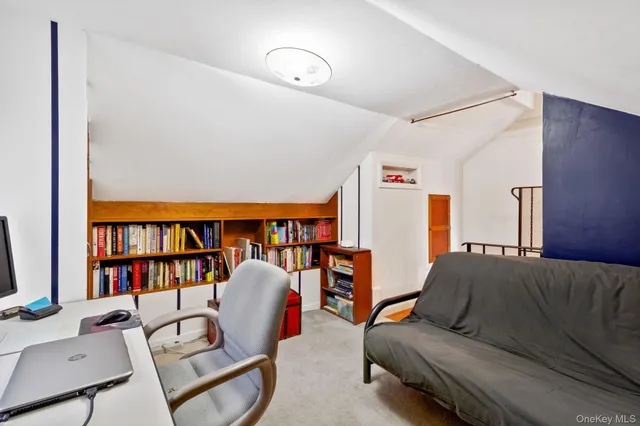 a living room with furniture a rug and a book shelf