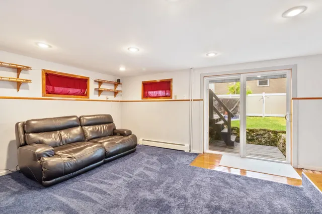 a living room with furniture and a floor to ceiling window