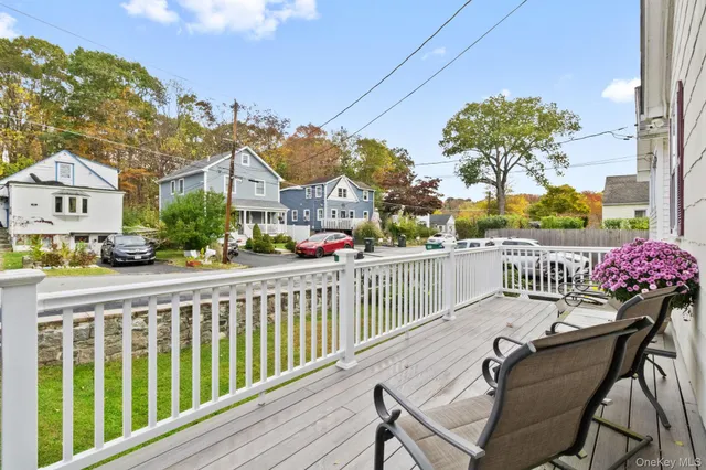 a view of a chair and tables in the balcony