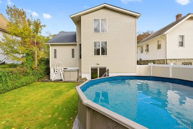 a view of an house with backyard space and balcony