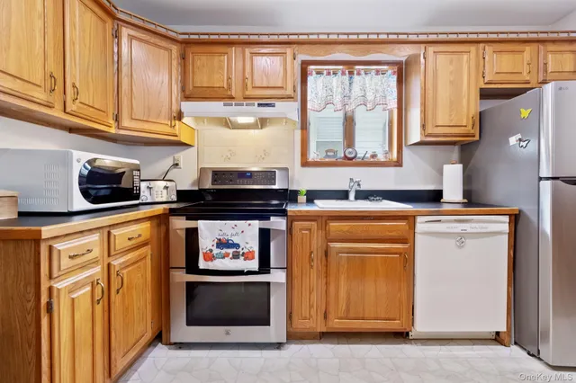 a kitchen with stainless steel appliances granite countertop a stove and a refrigerator