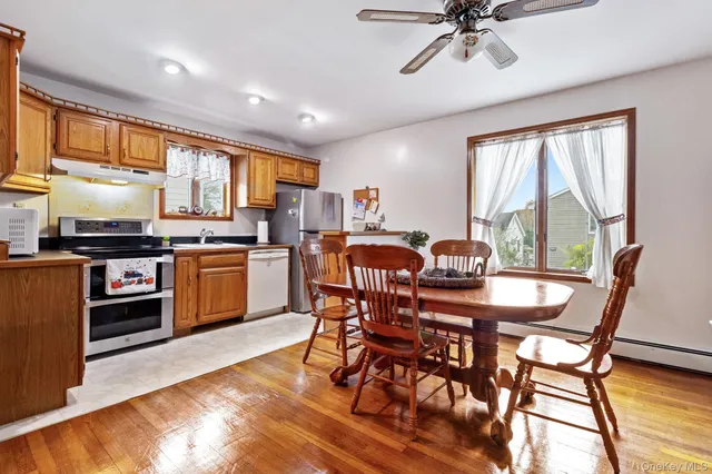 a view of a dining room with furniture window and wooden floor