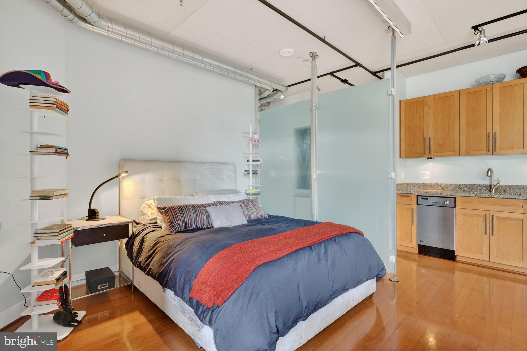 2125 14th Street Northwest, Unit 531 Washington, DC 20009 - Photo 12 of 20 a bedroom with a bed and a view of kitchen