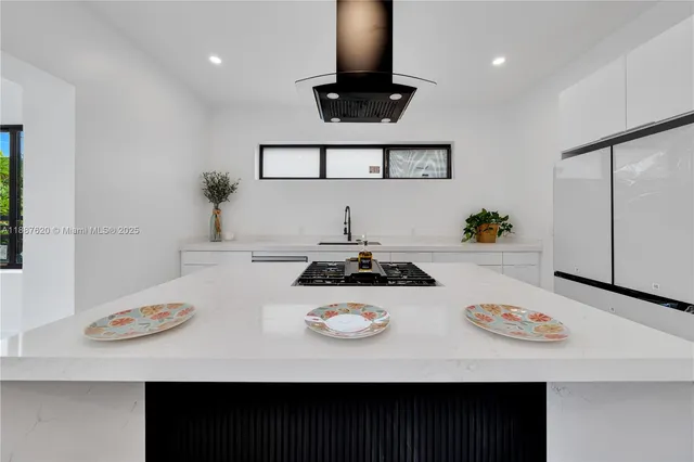 a white table sitting next to a white stove top oven with white countertops