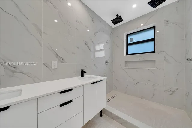 a bathroom with a bathtub and a shower
