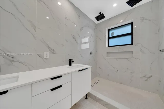 a bathroom with a bathtub and a shower