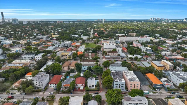 an aerial view of residential houses with city view