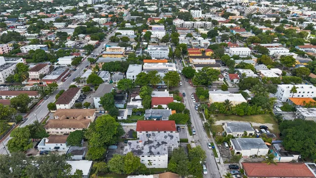an aerial view of residential houses with city view