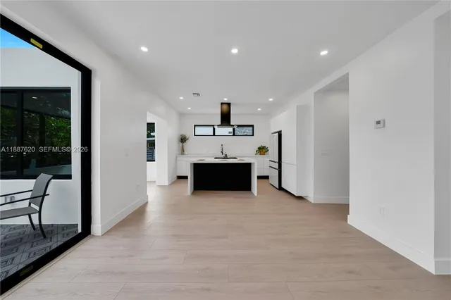 a view of a kitchen with a sink and cabinets