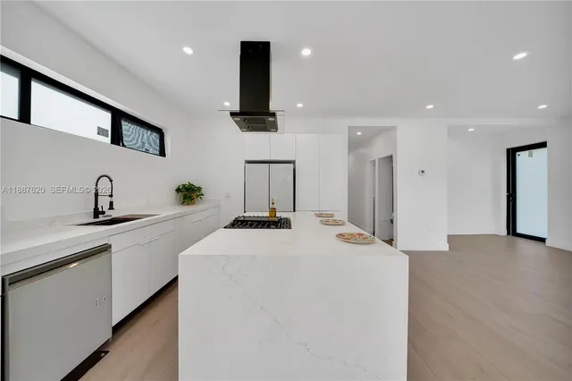 a kitchen with stainless steel appliances a sink and a refrigerator