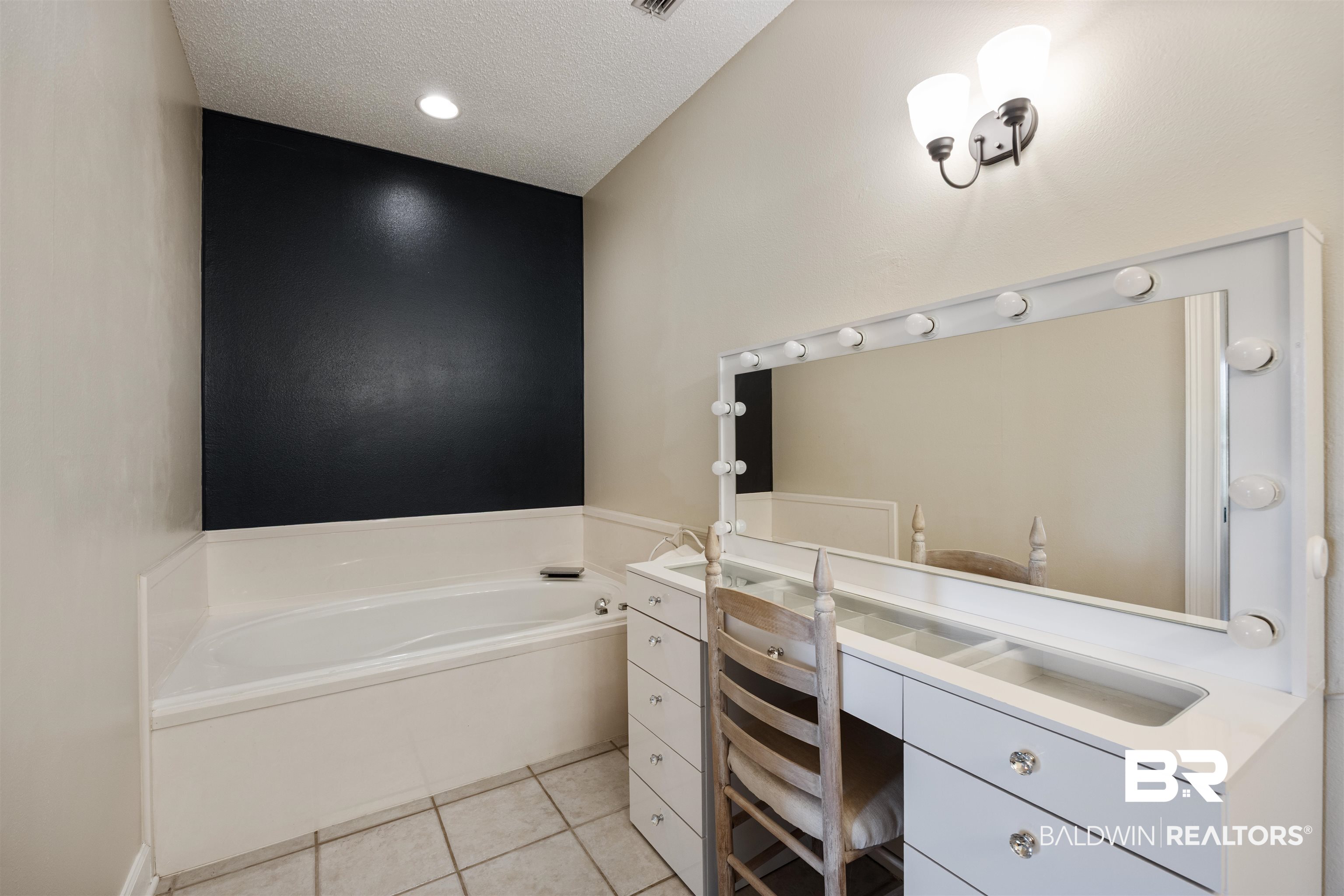9855 Stucki Road Elberta, AL 36530 - Photo 32 of 54 Full bathroom featuring vanity, a bath, a textured ceiling, and light tile patterned flooring